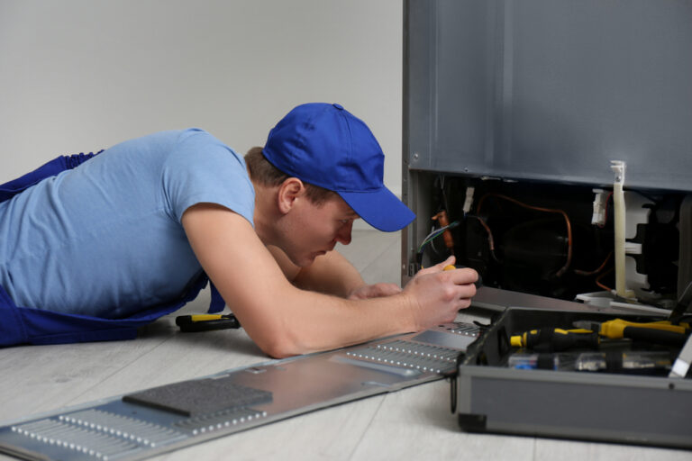 Male,Technician,With,Screwdriver,Repairing,Refrigerator,Indoors